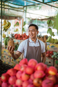 Portrait of smiling fruits for sale at market