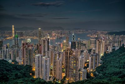 Aerial view of illuminated cityscape against sky at night