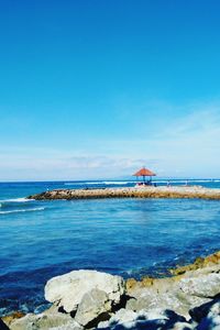 Scenic view of sea against blue sky