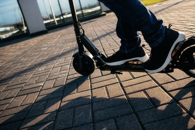 Low section of man on push scooter