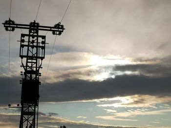 Low angle view of silhouette tower against sky during sunset