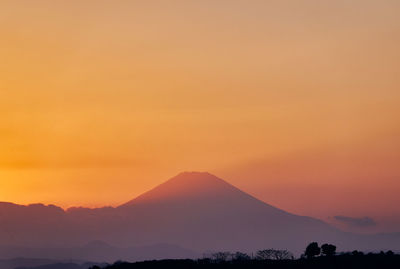 Scenic view of silhouette mountain against romantic sky at sunset