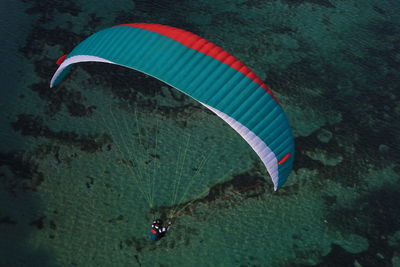 High angle view of people flying over water
