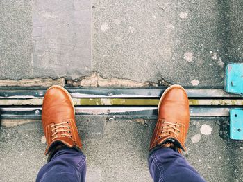 Low section of person standing on road