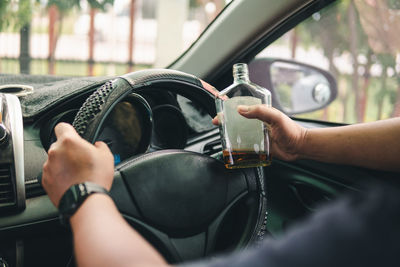 Cropped hand of man holding car