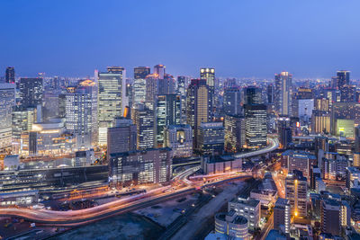 High angle view of illuminated buildings in city at night