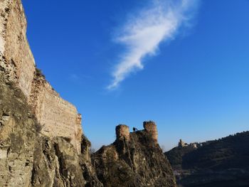 Low angle view of rock formation against sky