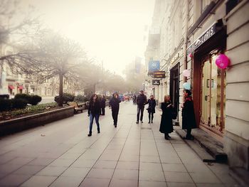 People walking on street in city