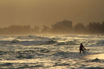 Waves in sea at sunset