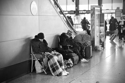 Rear view of people sitting at airport