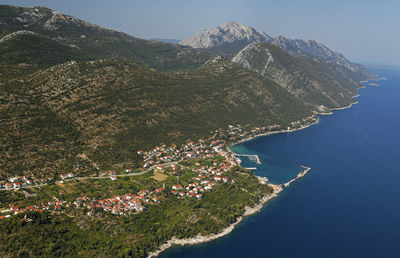 Scenic view of sea and mountains against sky