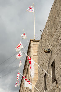 Low angle view of flags against sky