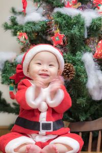 Cute baby girl with christmas tree