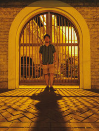 Portrait of young man standing on tiled floor