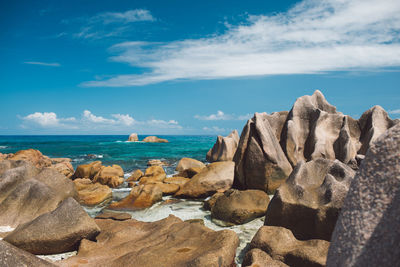 Rocks on beach against sky