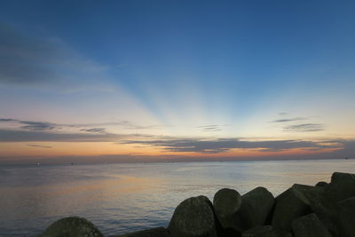 Scenic view of sea against sky at sunset