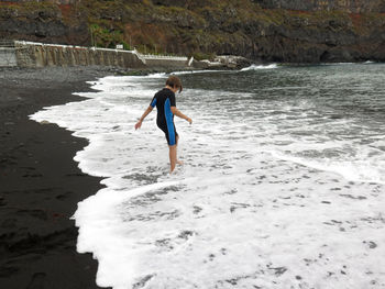 Girl standing on sea shore