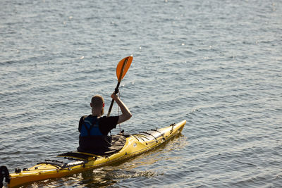 Man kayaking on sunny day