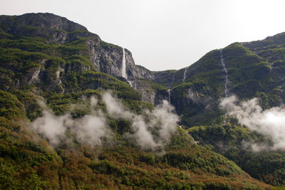 Scenic view of waterfall against sky