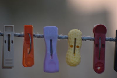 Close-up of clothespins hanging on clothesline