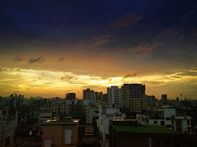 building exterior, sunset, architecture, built structure, city, cityscape, sky, orange color, cloud - sky, residential building, residential district, skyscraper, residential structure, city life, silhouette, high angle view, cloud, building, crowded, dusk