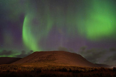 Low angle view of mountain against sky at night