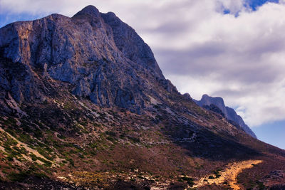 Low angle view of rock formation against sky