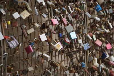 Padlocks hanging on railing