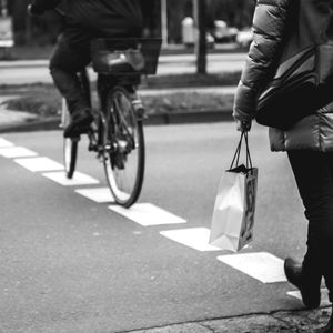 Person riding bicycle on road in city