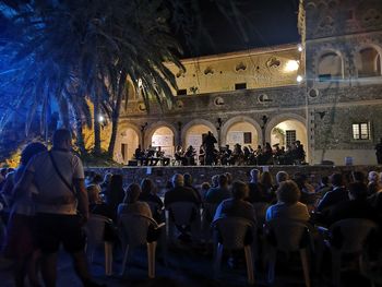 Group of people in illuminated building at night