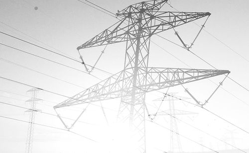 Low angle view of electricity pylon against sky