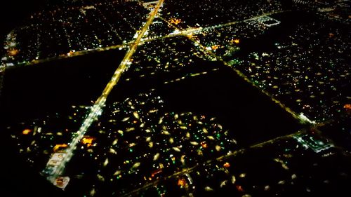 Close-up of illuminated water against black sky