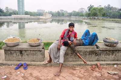 People sitting on riverbank