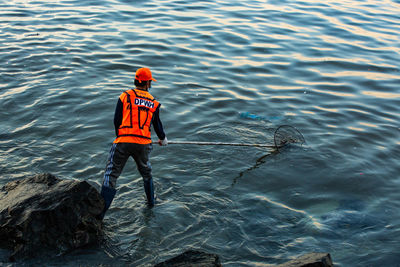 Rear view of man in sea