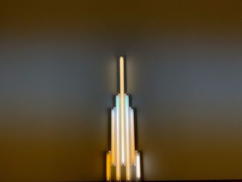 Close-up of illuminated light against wall