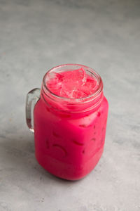 Close-up of pink jar on table