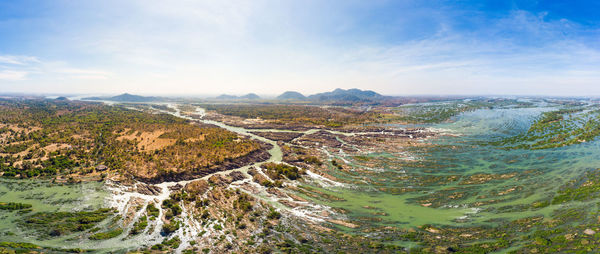 High angle view of land and sea against sky