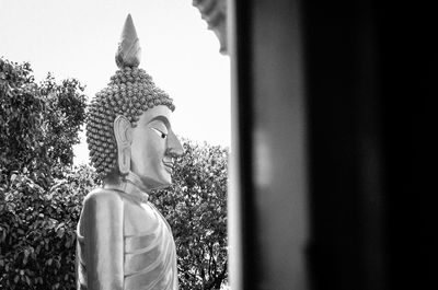 Statue of buddha against building