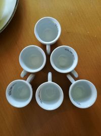 High angle view of coffee cups on table