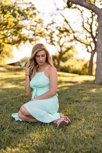 Full length of young woman on field