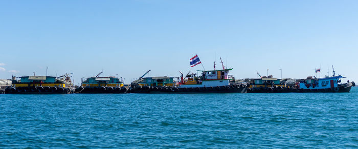 Ship in sea against clear blue sky