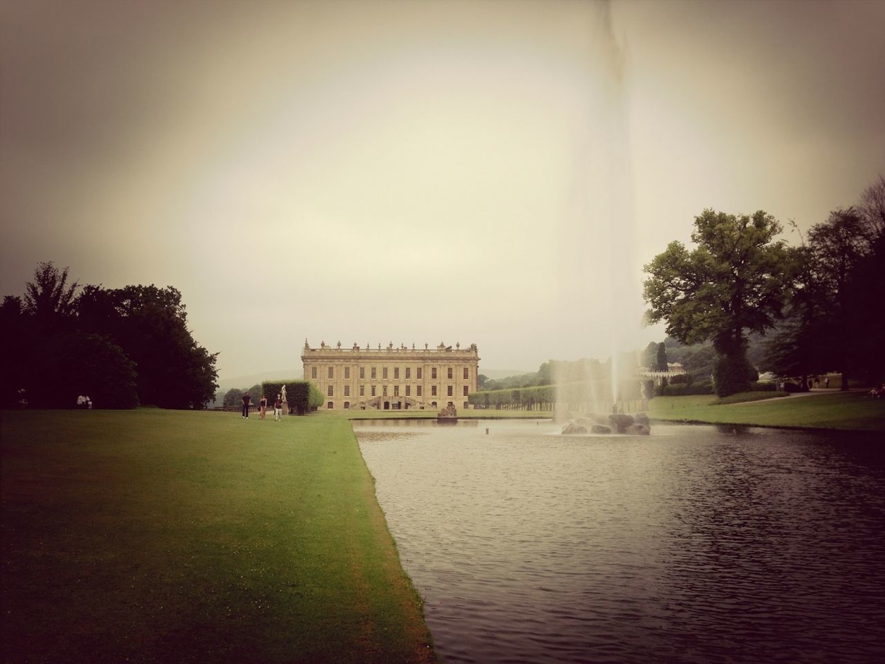 water, fountain, architecture, tree, built structure, building exterior, waterfront, statue, sculpture, sky, travel destinations, park - man made space, famous place, outdoors, incidental people, grass, tourism, nature, day, art and craft