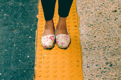 Standing on a yellow line with cute doll shoes
