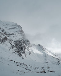 Scenic view of snow covered mountains against sky