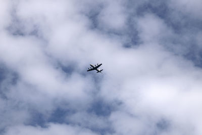 Low angle view of airplane flying in sky