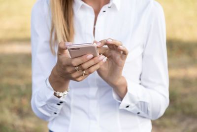 Midsection of woman using phone