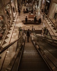 High angle view of people walking on escalator