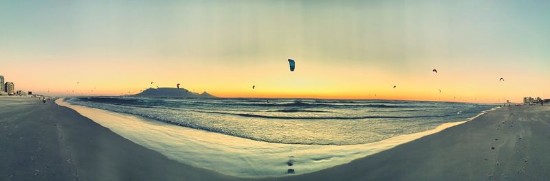 Scenic view of beach against sky during sunset