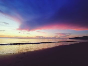 Scenic view of sea against romantic sky at sunset