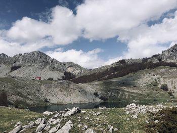 Scenic view of land and mountains against sky